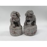 19th century Chinese Buddhistic lions - A pair of stone Buddhistic lions on circular bases, remnants