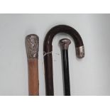 Silver topped walking sticks - Two silver topped canes and a walking stick, longest height 92cm.