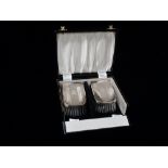 Silver - A pair of silver engine turned hair brushes, Birmingham 1962, boxed.