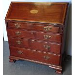 Georgian bureau - A walnut bureau with four graduated drawers on ogee feet with a crossbanded