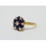A sapphire and diamond floral shaped cluster ring - set in 18ct yellow gold, size M, weight 4.1g.