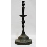 A 19th century bronze Middle Eastern candlestick - of large proportions and raised of a dome