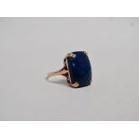 A lapis lazuli dress ring - A polished rectangular stone claw set in 9ct yellow gold, size O, weight