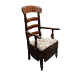 A 19th century walnut ladderback commode chair - with open arms, a removable seat and raised on