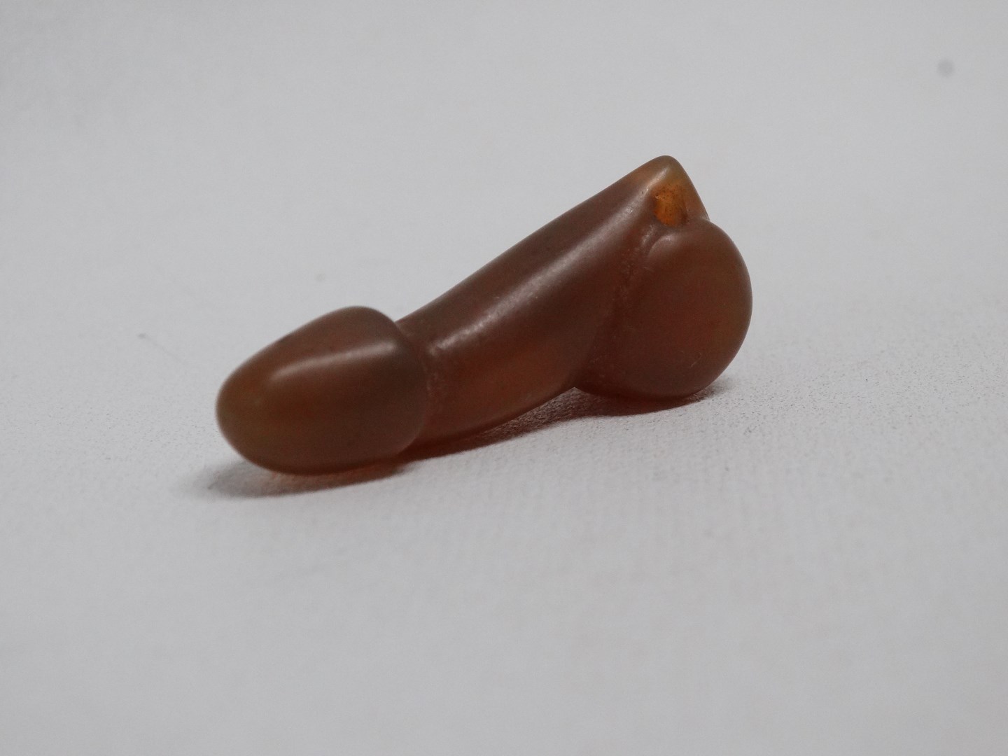 A 19th century hardstone phallus - length 4cm, together with another similar smaller one. - Image 3 of 5