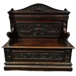 A late 19th century continental walnut hall bench - the back extensively carved griffins above