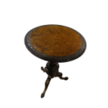 A Victorian walnut occasional table - the circular top with foliate banding on a carved baluster