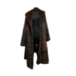 A ladies fur coat - with a broad collar, bell sleeves, velvet lined pockets and chocolate brown