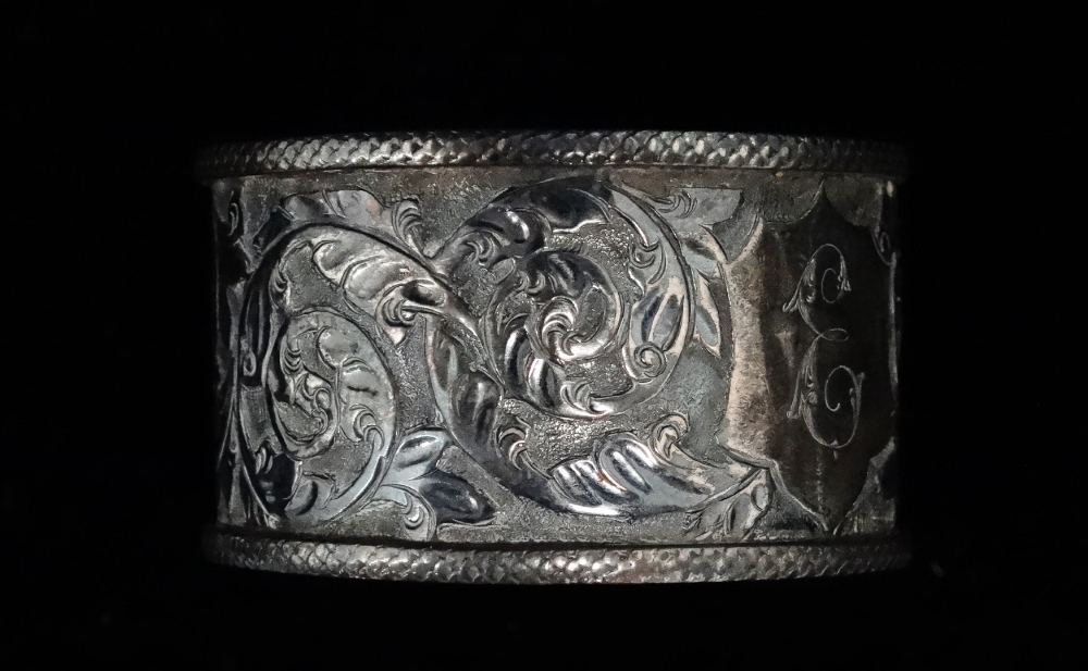 An Indian silver double egg cup - Repousse decorated with deities, 10cm (high), together with a pair - Image 7 of 7