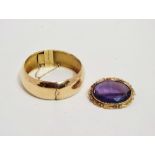 A late 19th century amethyst brooch - the oval faceted stone in a yellow metal foliate frame, length