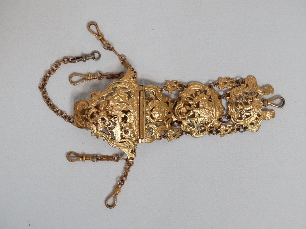 A late 19th century continental ormolu chatelaine - the pierced and engraved decoration showing