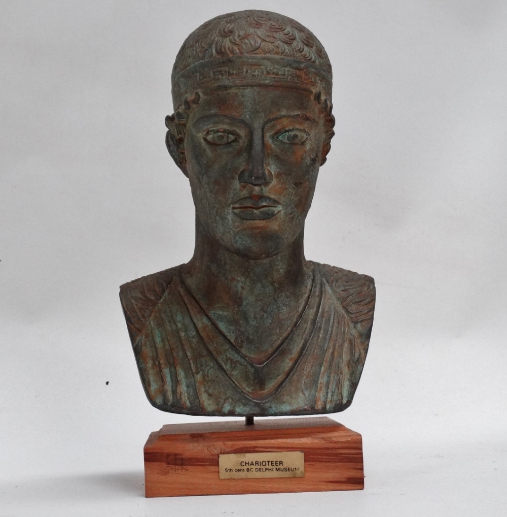 Bust of a charioteer - modelled in terracotta with a Verdigris finish, raised on a beech plinth,