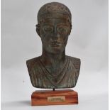 Bust of a charioteer - modelled in terracotta with a Verdigris finish, raised on a beech plinth,