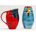 A Poole Pottery jug - iris flower decoration, on a mottled red ground, height 22cm, together with