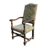 An early 18th century walnut open armchair - upholstered in verdure tapestry, on square and turned