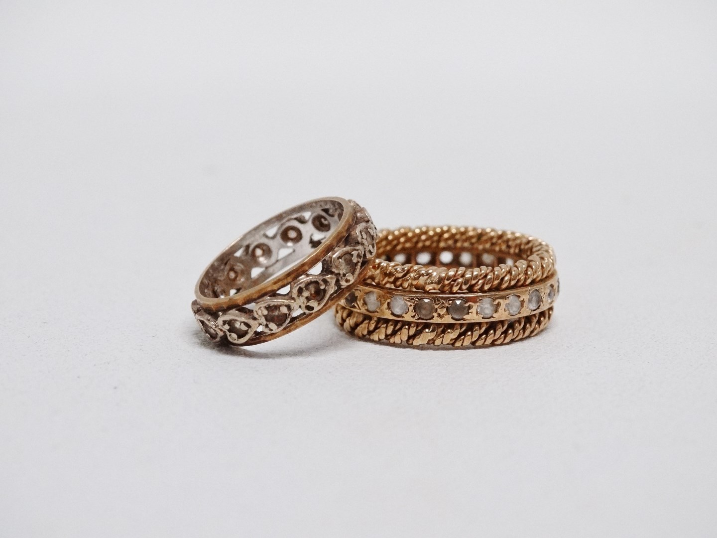 A 9ct yellow gold eternity ring - the diamond chips within heart shape settings, size J, together