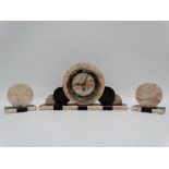 A Art Deco marble mantel clock garniture - pink marble with black slate and an arrangement of disks,