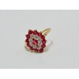 A ruby and diamond dress ring - of stepped navette shape, claw set in a 9ct yellow gold band, size