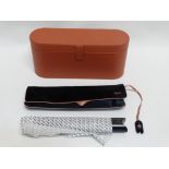 A Dyson Corrale hair straightener - in a faux tan leather case, with travel bag and instructions,