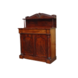 An early Victorian mahogany chiffonier - the foliate raised back with a shelf above an inverted