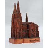 A 20th century musical box - cast bronzed metal and modelled as Cologne cathedral, width 15cm.