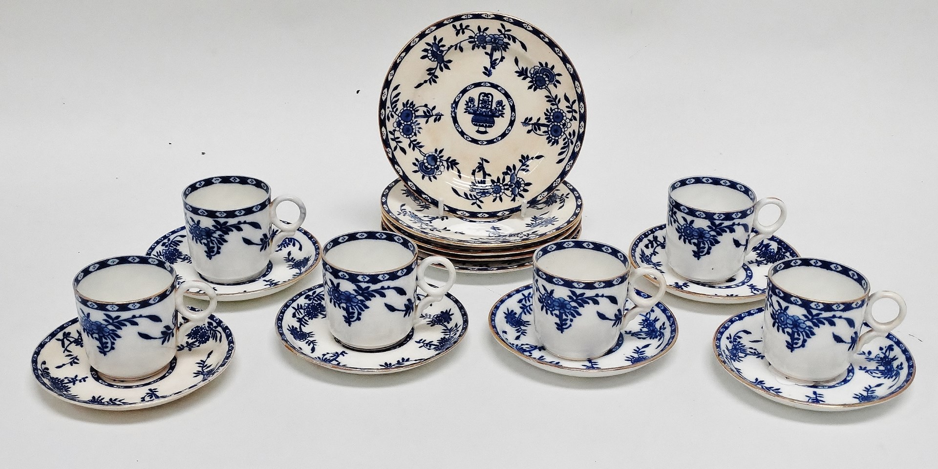 An early 20th century coffee service - blue floral decoration with gilt rims, six settings with