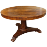 An early Victorian rosewood tilt top breakfast table - on a tapering octagonal support and triform