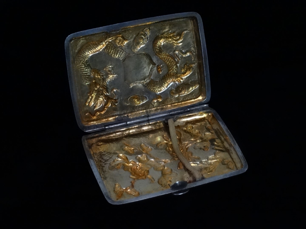 An early 20th century Chinese white metal cigarette case - decorated with a dragon amongst clouds, - Image 3 of 5