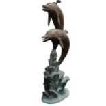 A bronze dolphin fountain - modelled as two dolphins leaping above the surf, height 125cm. Note: