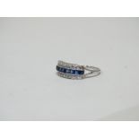 A sapphire and diamond ring - the square channel set sapphires flanked by rows of diamonds in a