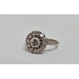 Diamond cluster ring - the central claw set stone of .75ct approximately within a band of smaller