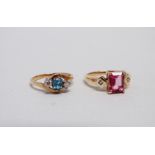 A pink tourmaline and diamond dress ring - the emerald cut central stone flanked by diamonds on a