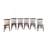 A set of six early 20th century walnut stick-back chairs - with solid circular seats on turned