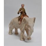In the manner of Royal Dux - an elephant and rider, height 27cm.