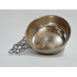 A silver wine taster - Chester 1913, with a scrolled pierced lug handle, 3oz