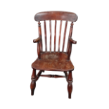 A late 19th century beech and elm child's armchair - the arched top rail above a stickback and