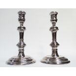 A pair of silver candlesticks by Mappin & Webb - London 1968, double knopped stem on a circular