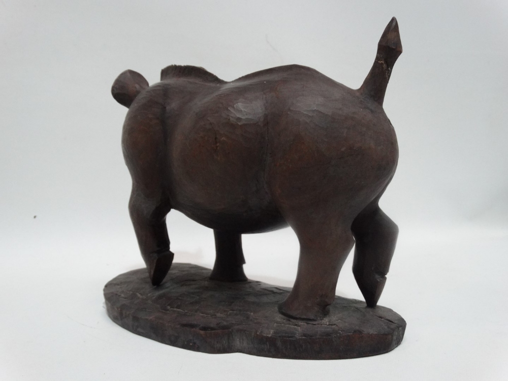 A carved exotic hardwood model of a warthog - standing on a naturalistic base, signed Nganga, height - Image 3 of 5
