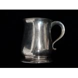 A silver baluster shaped tankard, London 1925, sponsor's mark for Edward & Sons, engraved to base,