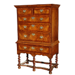 A George II burr walnut chest on stand - the cornice above an arrangement of two short and three