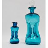 Holmegaard decanters - two Holmegaard blue glass 'Kluk Kluk' decanters, the largest with stopper,