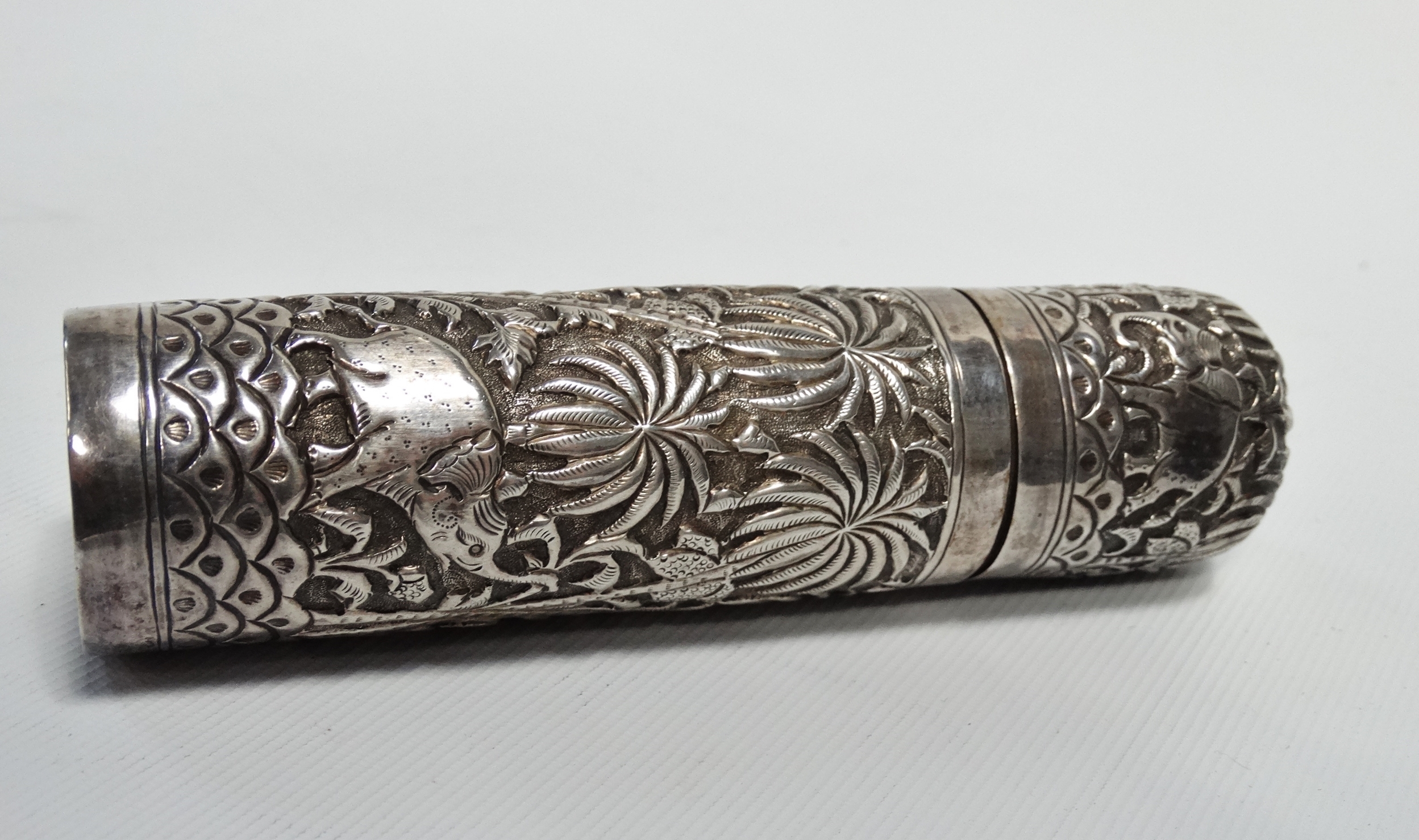 An Indian silver cylindrical box - Repousse decorated with elephants, tigers and stag in a palm - Image 2 of 7