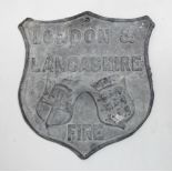 A reproduction lead fire plaque - London & Lancashire, of shield shape, height 22cm.