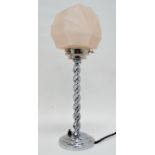 An Art Deco chrome table lamp - the spiral twist support on a circular base with a pink glass