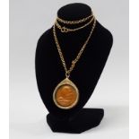 Thai Coin Buddha Necklace - An 18ct gold captive cased coin on .585 (14ct) gold chain, the bronze