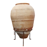 A large terracotta olive oil jar - of typical ovoid form with an incised waved band to centre and