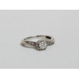 A diamond set ring - crossover with diamond shoulders, set in 18ct white gold, size I, weight 1.2g.