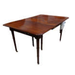 A late George III mahogany dining table - the rectangular top with four leaf insertions on ring