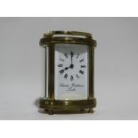 A 20th century carriage timepiece - Charles Frodsham, London, the oval brass case fitted with