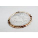 A late 19th century oval cameo brooch - the panel showing a charioteer within a yellow metal